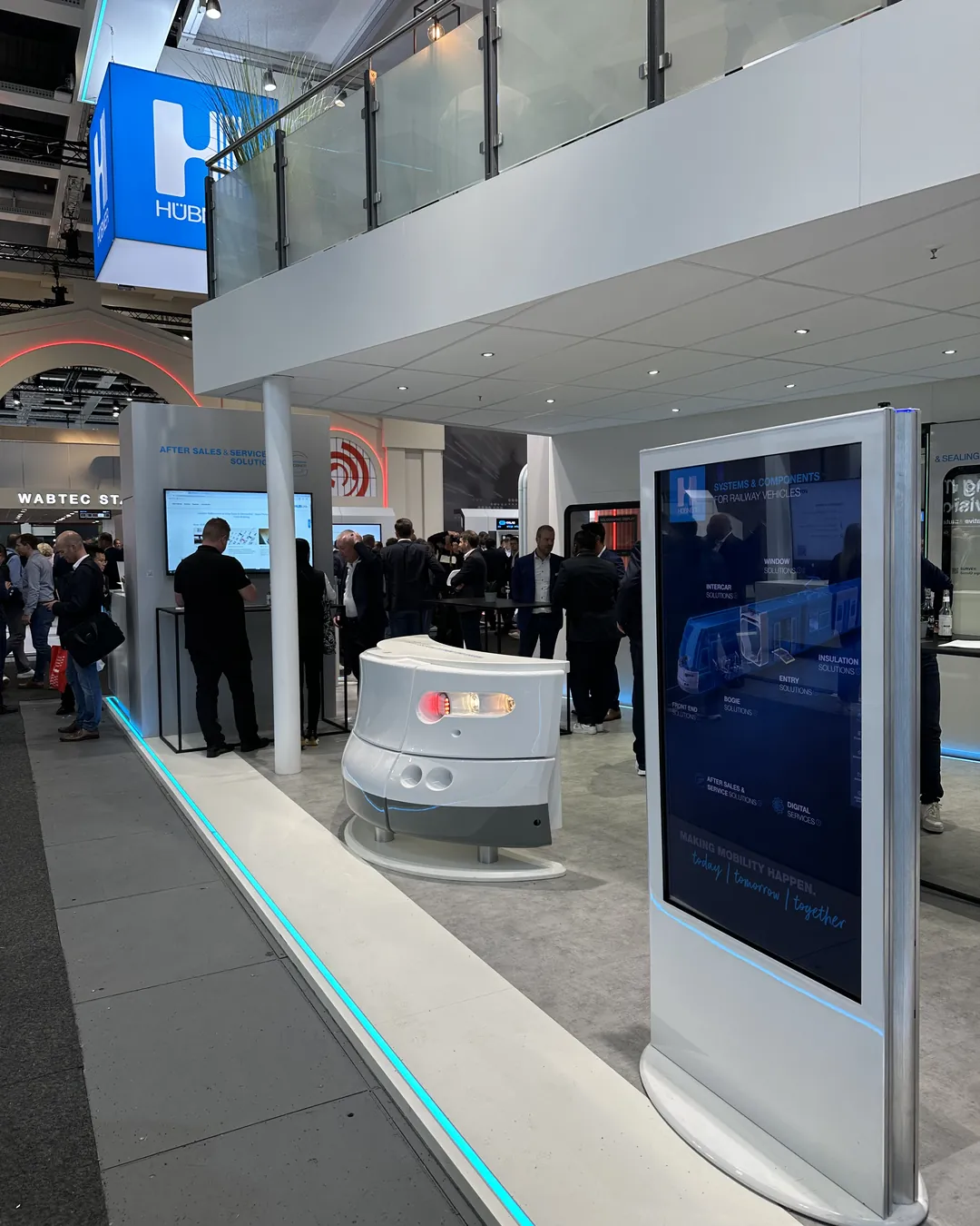 HÜBNER Group - InnoTrans 2024: Portrait Stele with the Rail App at the HÜBNER Booth